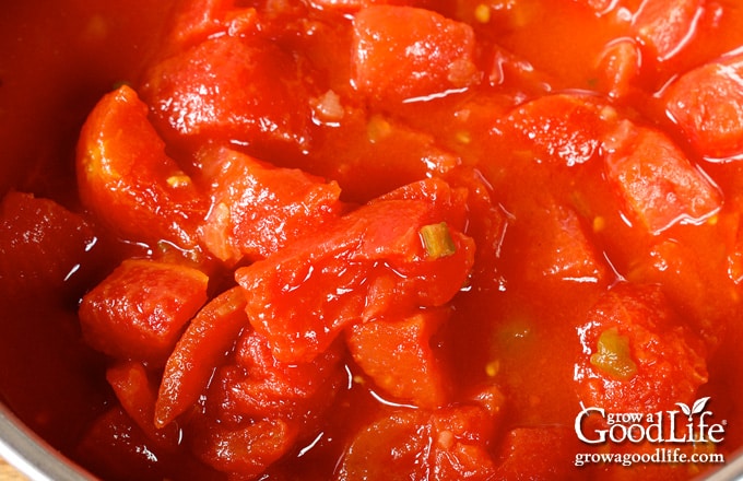 Over head view of stewed tomatoes simmering in the pot.