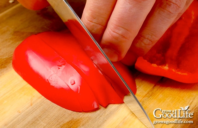 Close up view of slicing the peppers into strips.