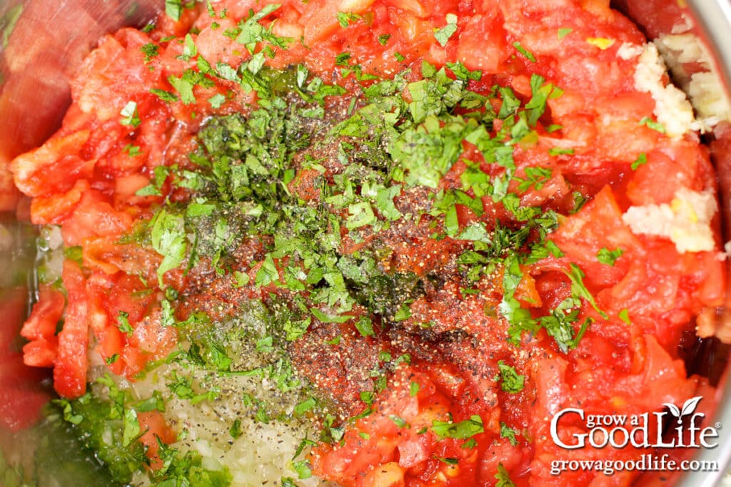 Close up view of the prepared salsa ingredients in a large pot.