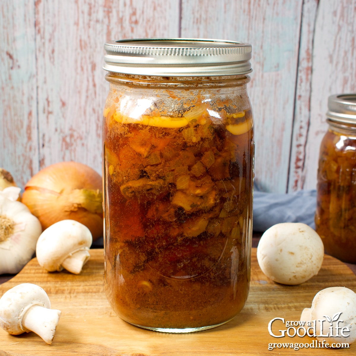 Mason jars of home canned beef stroganoff on a table.