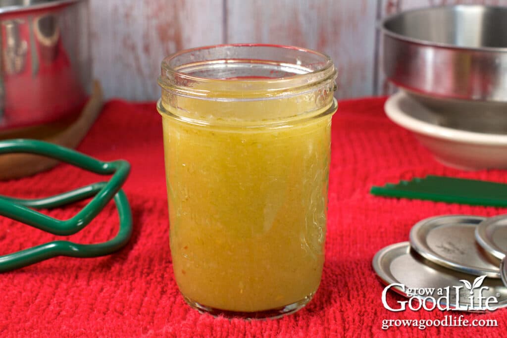 Filling a jar with green chile enchilada sauce.