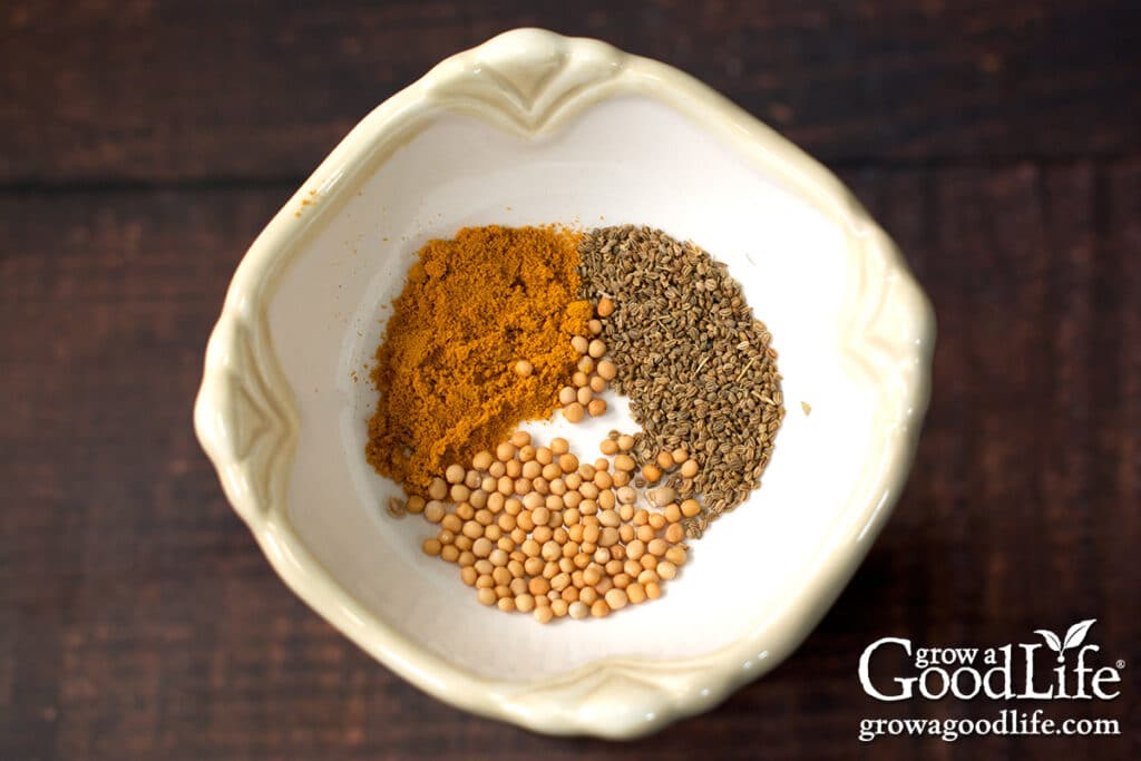 Close up of spices in a bowl for pickled summer squash.