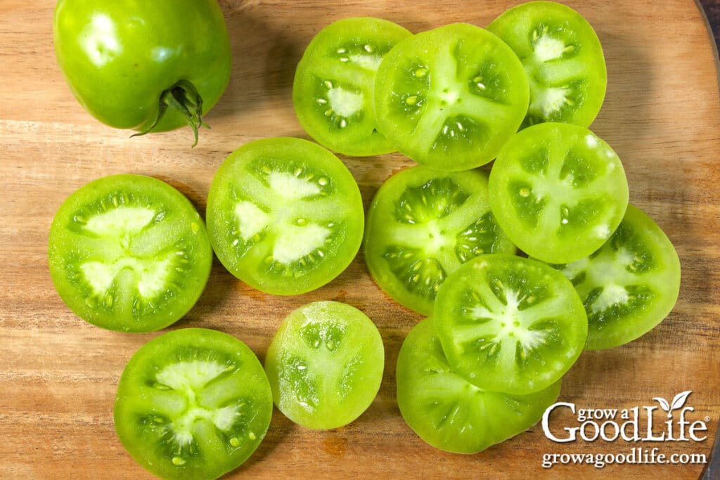 Sliced green tomatoes on a cutting board.