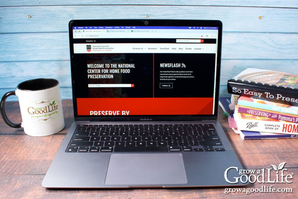 A laptop with the National Center for Home Food Preservation website on the screen.