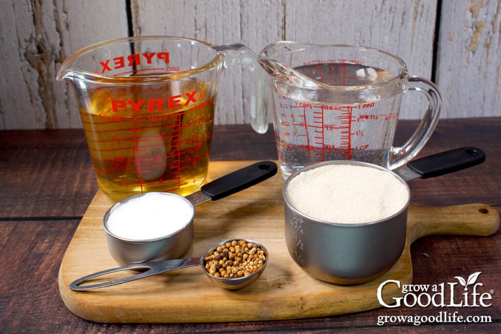 Measured vinegar, water, salt, sugar, and pickling spice ingredients to make a batch of pickling brine.