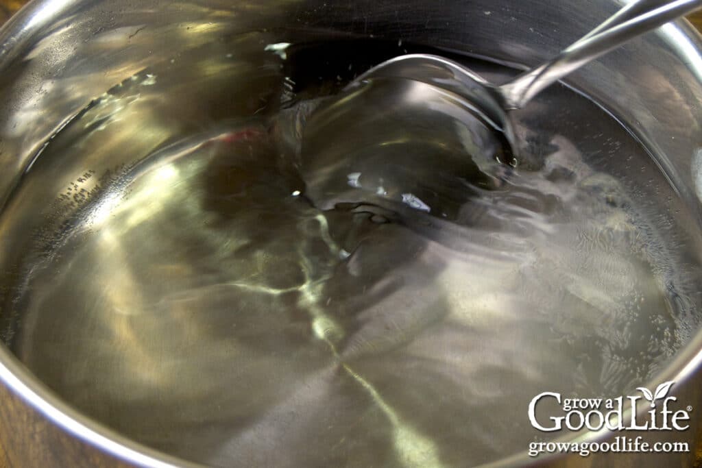 Overhead view of a batch of pickling brine in a pot on the stove.