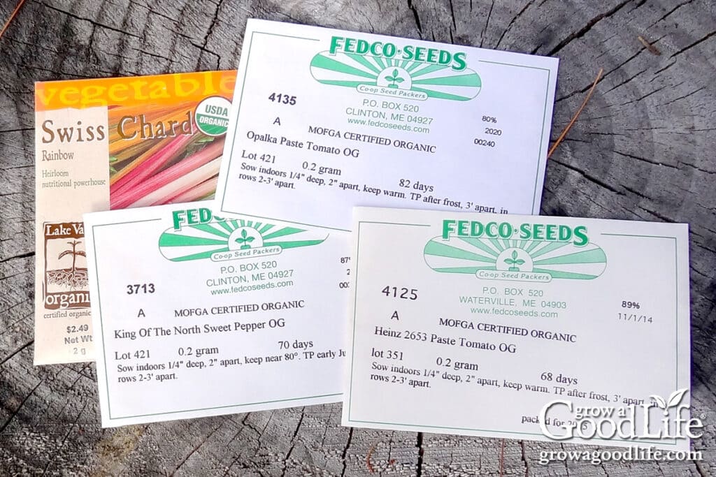 Overhead view of several organic seed packages on a table.
