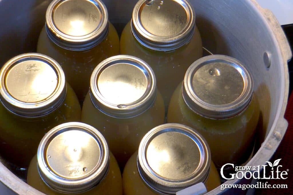 Overhead view of a canner load of filled quart sized jars.