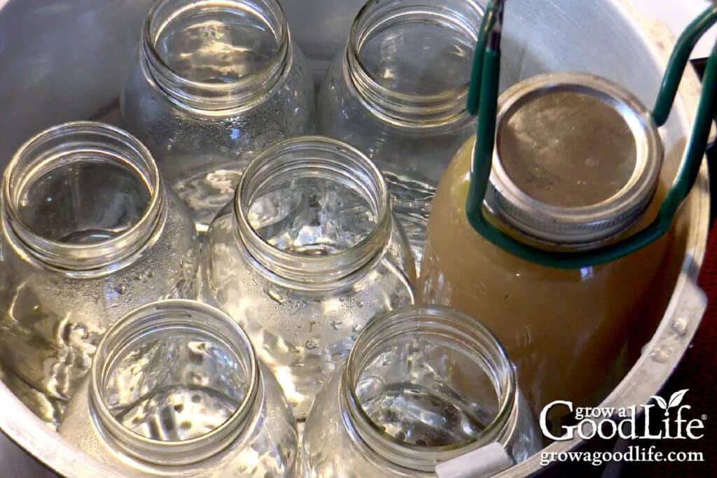 Placing the jar in the canner using the jar lifter tool.
