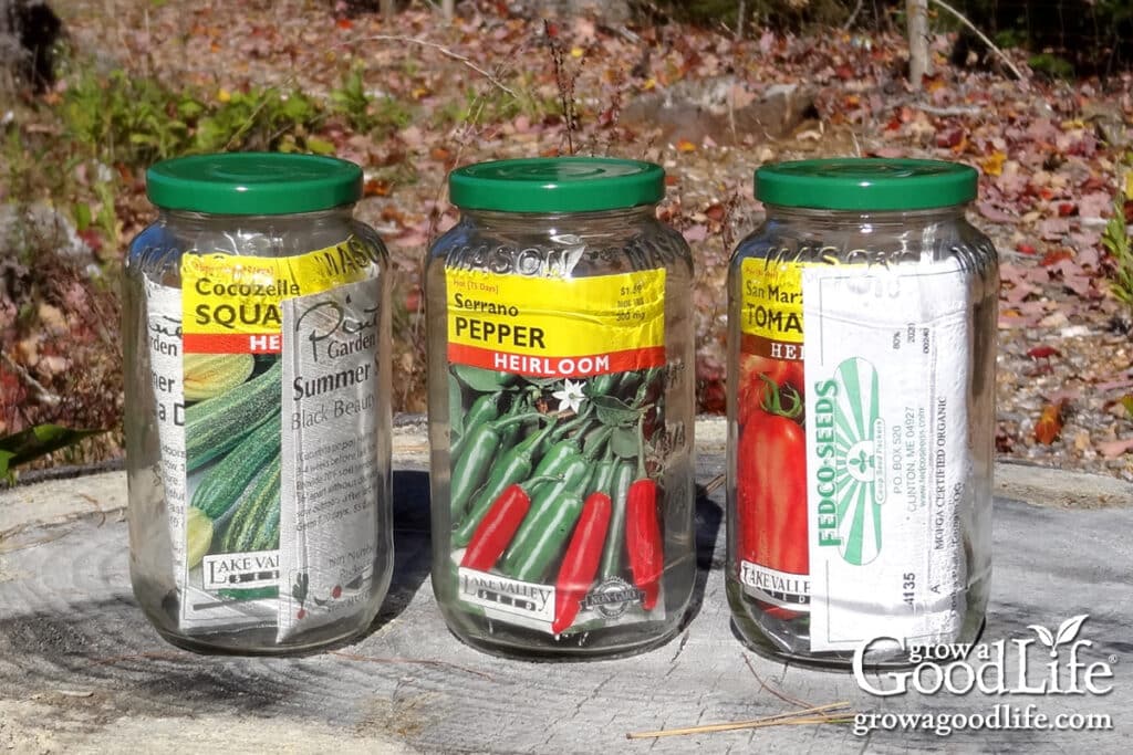 Three jars of garden seeds for storing.