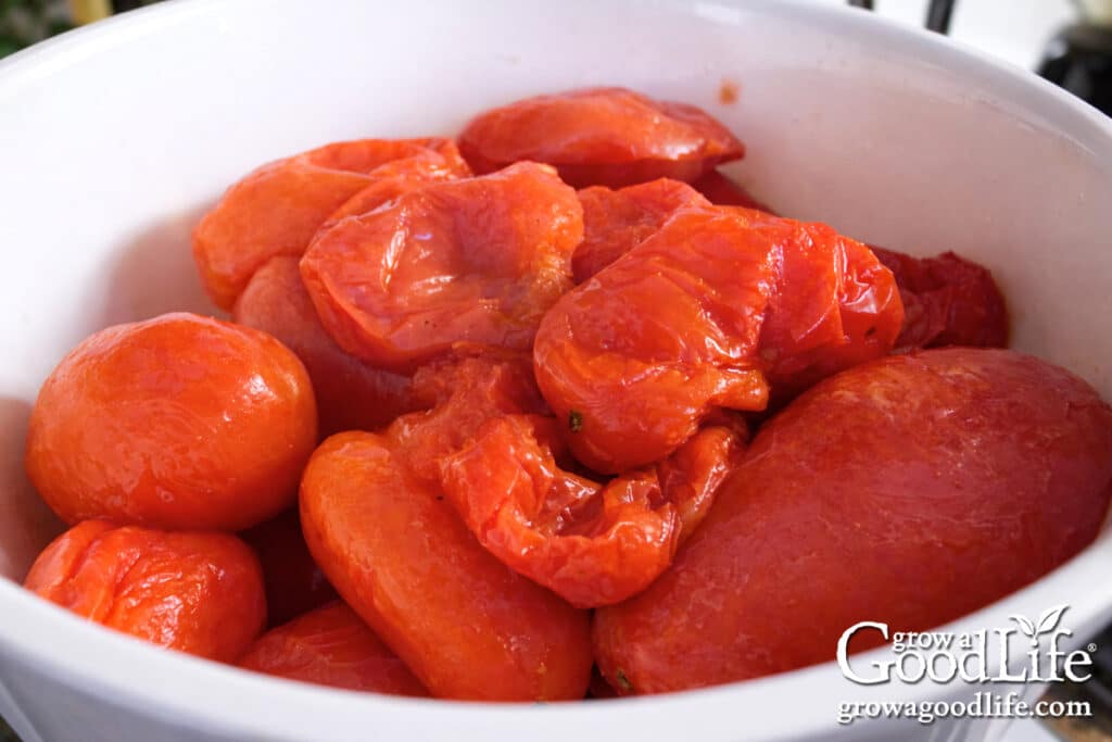 Thawed frozen tomatoes in a white bowl showing soft texture.