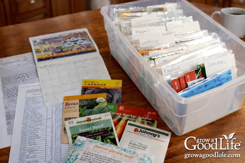 Seed starting schedule and seed packets spread out on a kitchen table.
