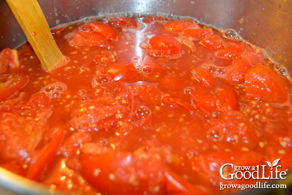 Cooked tomatoes reduced and ready to strain for smooth tomato basil sauce for canning.