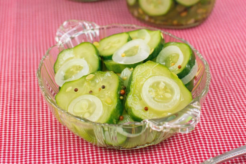 Close-up of bread and butter pickles with sliced cucumbers and onions.
