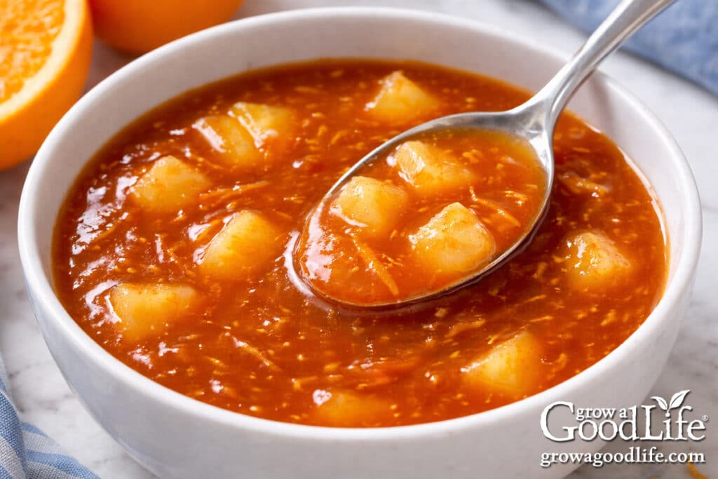 Finished orange sweet and sour sauce and pineapple in a bowl ready to use.
