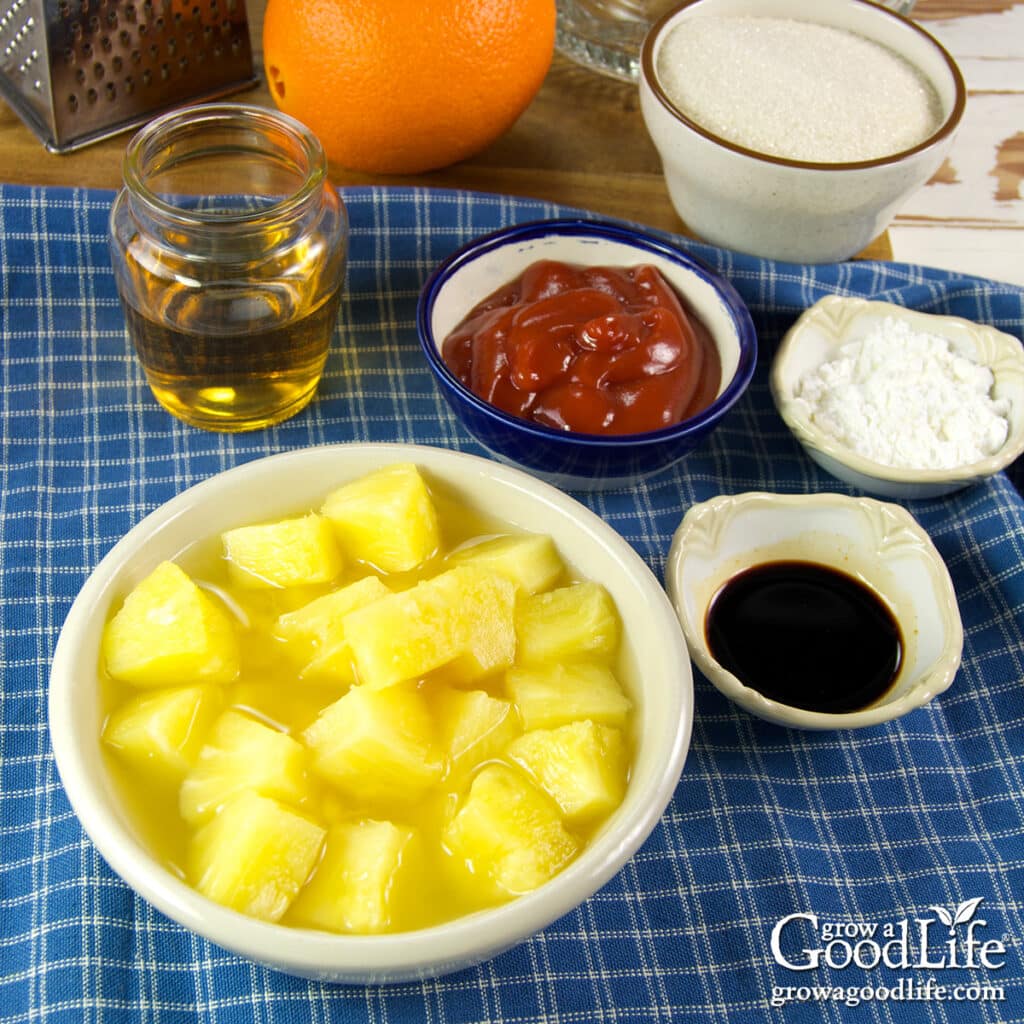 Ingredients for orange sweet and sour sauce including pineapple, orange, ketchup, vinegar, sugar, soy sauce, and cornstarch.