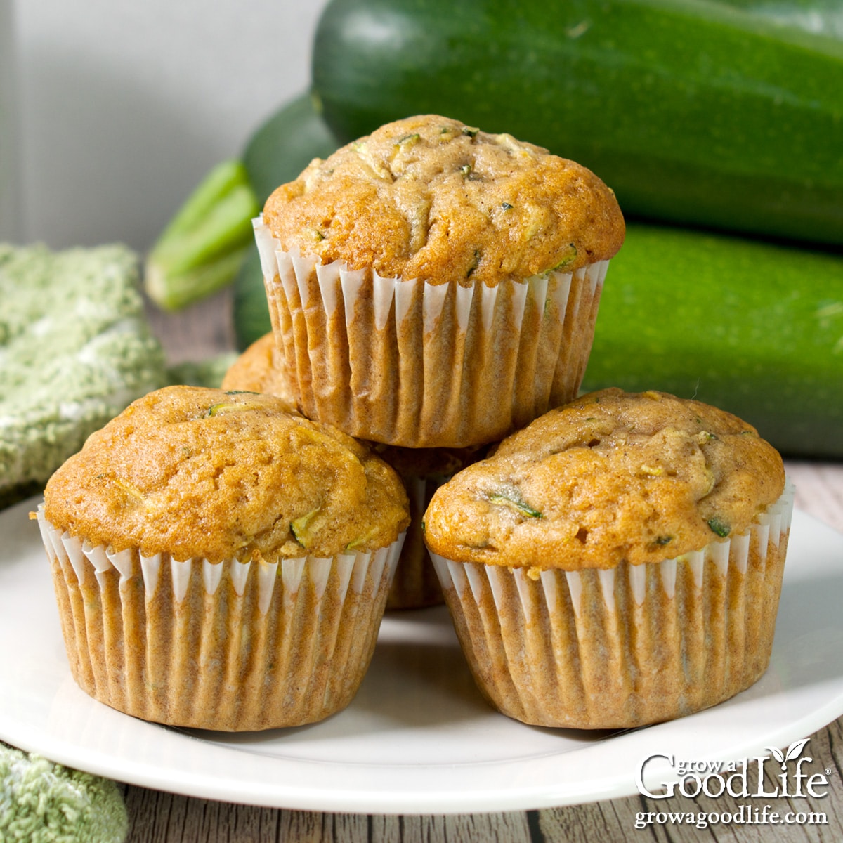 Stack of homemade zucchini muffins on a plate.