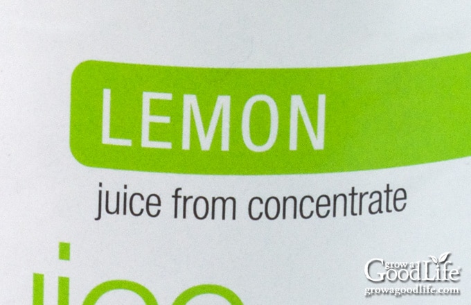 Close-up of a bottled lemon juice label showing the words "juice from concentrate."